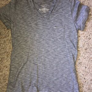 a white and black striped tee with a chest pocket.